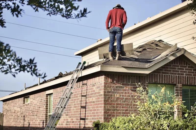 Professional roofer working on a residential roof in Hickory Lakes